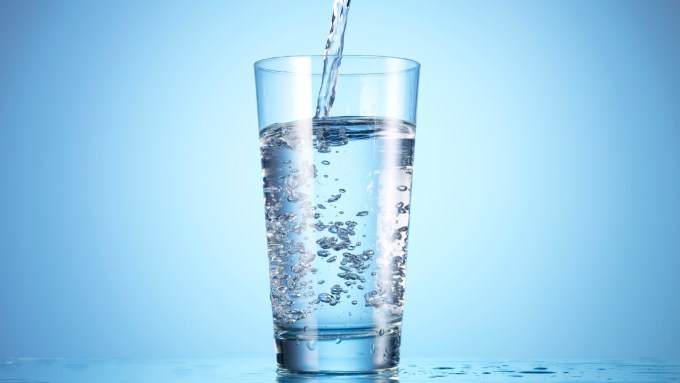 water being poured into a clear glass